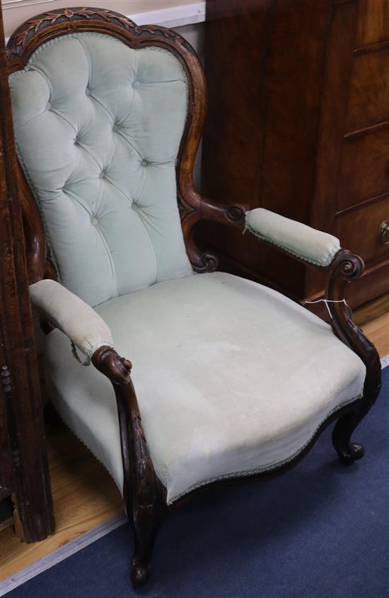 A Victorian carved walnut open armchair